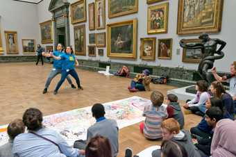 Two dancers performing to a crowd in the gallery