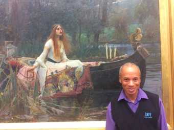 A person standing in front of a painting of a woman on a boat