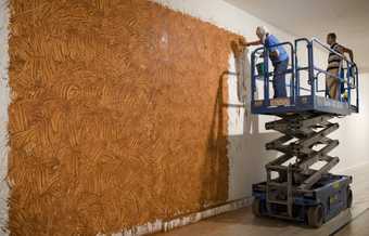 Mikei with artist Richard Long as he installs his wall drawing From Beginning to End for his 2009 exhibition at Tate Britain